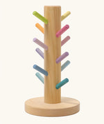 Grimms wooden sorting helper for rings with pastel dowels and a round natural base