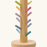 Grimms wooden sorting helper for rings with pastel dowels and a round natural base