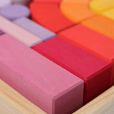 Close up of the Grimm's large Romanesque building set blocks in the wooden storage display tray. 
