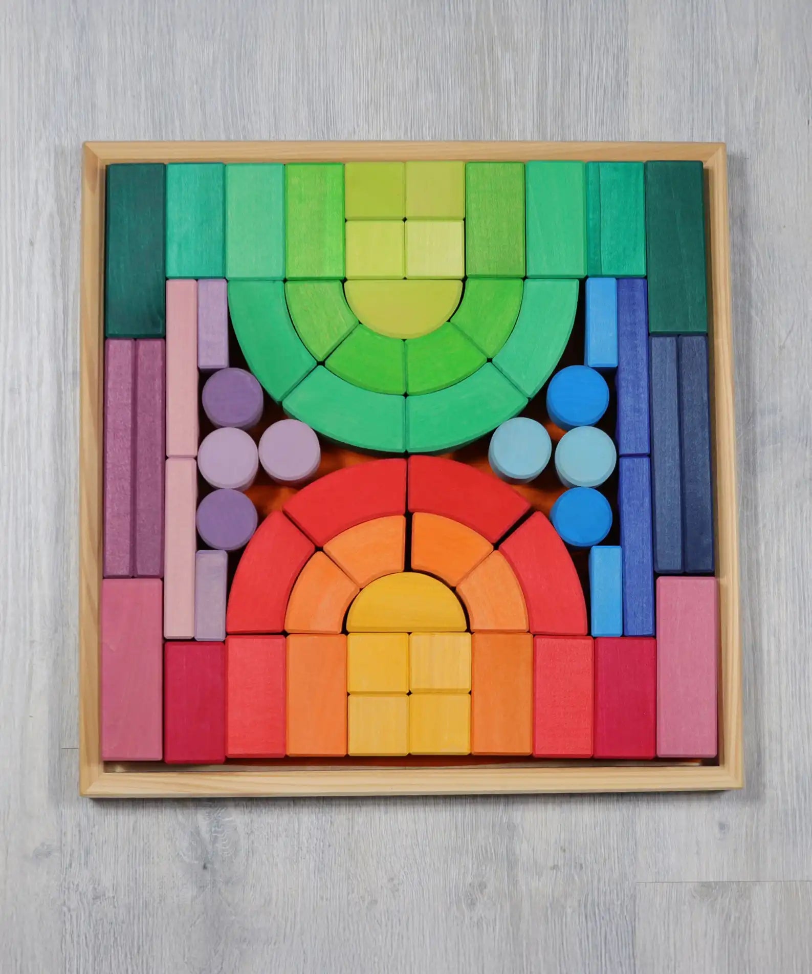 Grimm's large Romanesque wooden building block set in a wooden storage display tray.