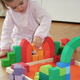 Child playing with the Grimm's large Romanesque building set.