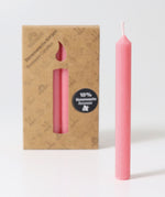 Grimm's Old Rose 10% Beeswax Candles in a 12 Pack with a single candle taken out of the box and placed at the front. 