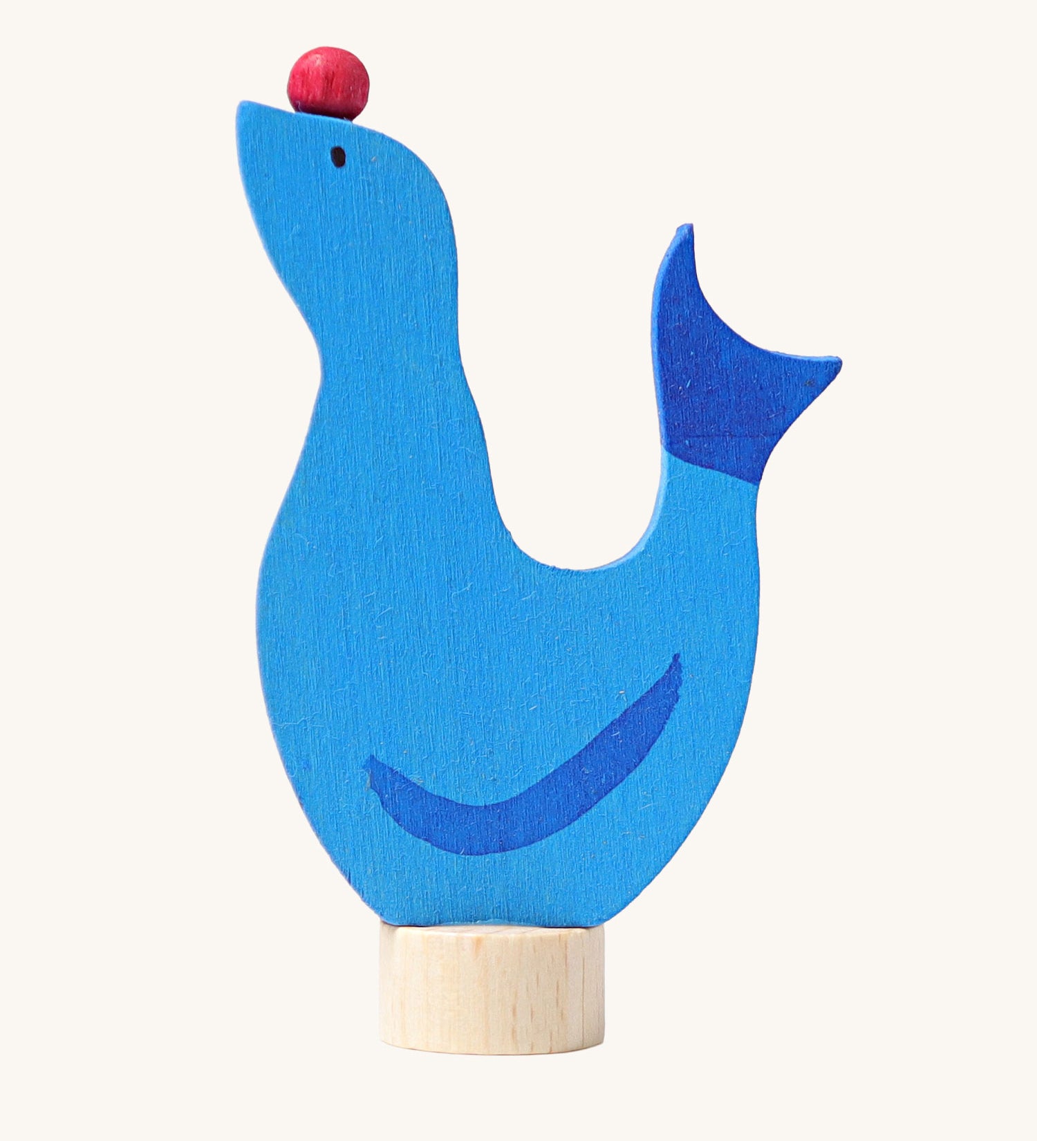Grimm's wooden seal decorative figure, a blue coloured seal with a red ball on it's nose to fit onto a Grimm's celebration ring. These Waldorf inspired decorative figures are part of a wide range of wooden decorations for celebration rings available here at Babipur.