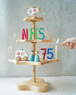 A Grimm's seasonal festivity stand decorated to celebrate the NHS's 75th birthday. The decorations Include a Bajo helicopter and ambulance