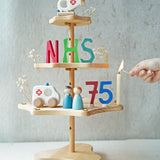 A Grimm's seasonal festivity stand decorated to celebrate the NHS's 75th birthday. The decorations Include a Bajo helicopter and ambulance