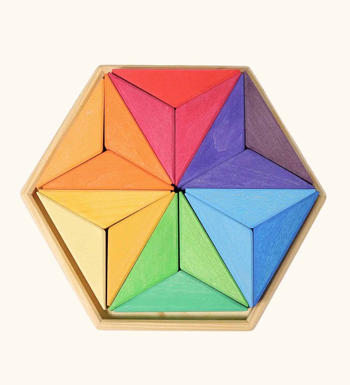 Grimms star complementary set. Contains 18 handcrafted wooden triangular pieces in a rainbow palette made for building and creative play