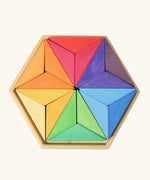 Grimms star complementary set. Contains 18 handcrafted wooden triangular pieces in a rainbow palette made for building and creative play