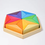 Grimms star complementary set. Contains 18 handcrafted wooden triangular pieces in a rainbow palette and tray