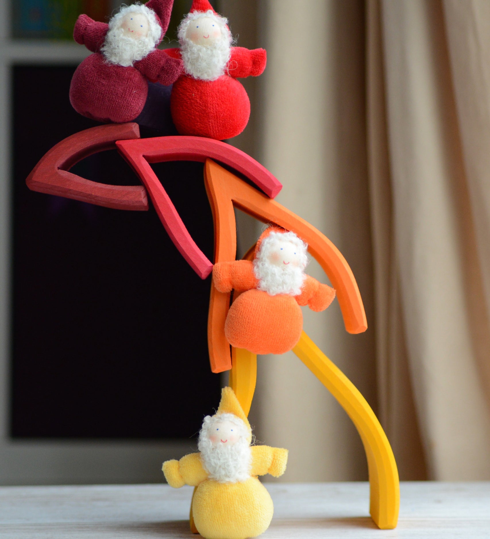 Flame shaped pieces from the Grimms fire set stacked with dwarf dolls standing on top