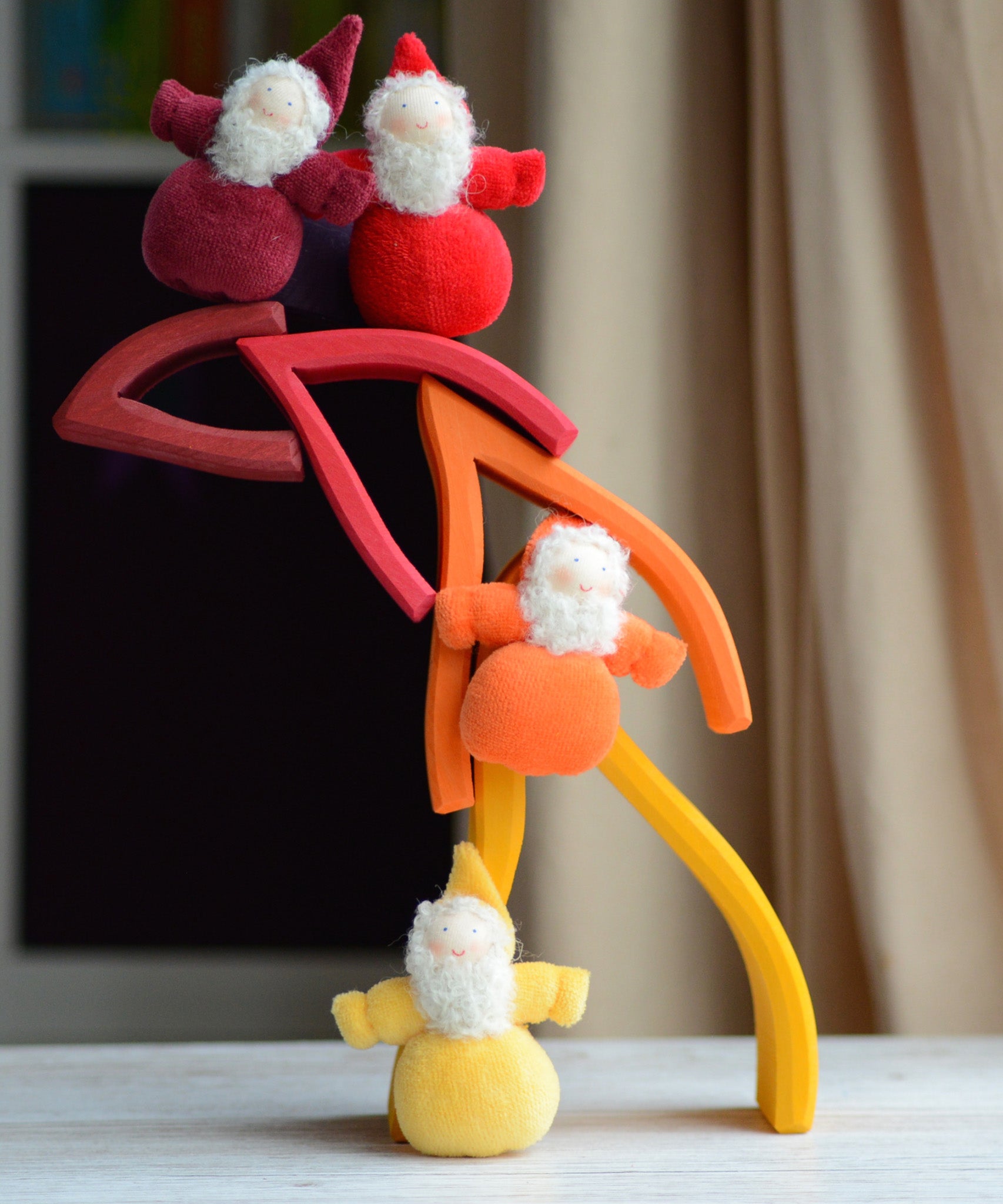Flame shaped pieces from the Grimms fire set stacked with dwarf dolls standing on top