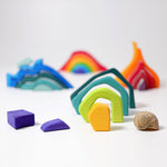 Pieces from the Grimm's Small 4 Elements Building Set taken out of the wooden storage and display case. The pieces of the earth element can be seen in the front.