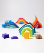 Pieces from the Grimm's Small 4 Elements Building Set taken out of the wooden storage and display case. The pieces of the earth element can be seen in the front.