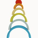 The Grimm's Babi Gwawr Sunrise 6 Piece Rainbow on a plain background. The pieces have been stacked on top of each other with the largest arch at the bottom and the smallest on top. 
