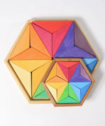 Grimms large and small star complementary wooden puzzle sets in a rainbow palette