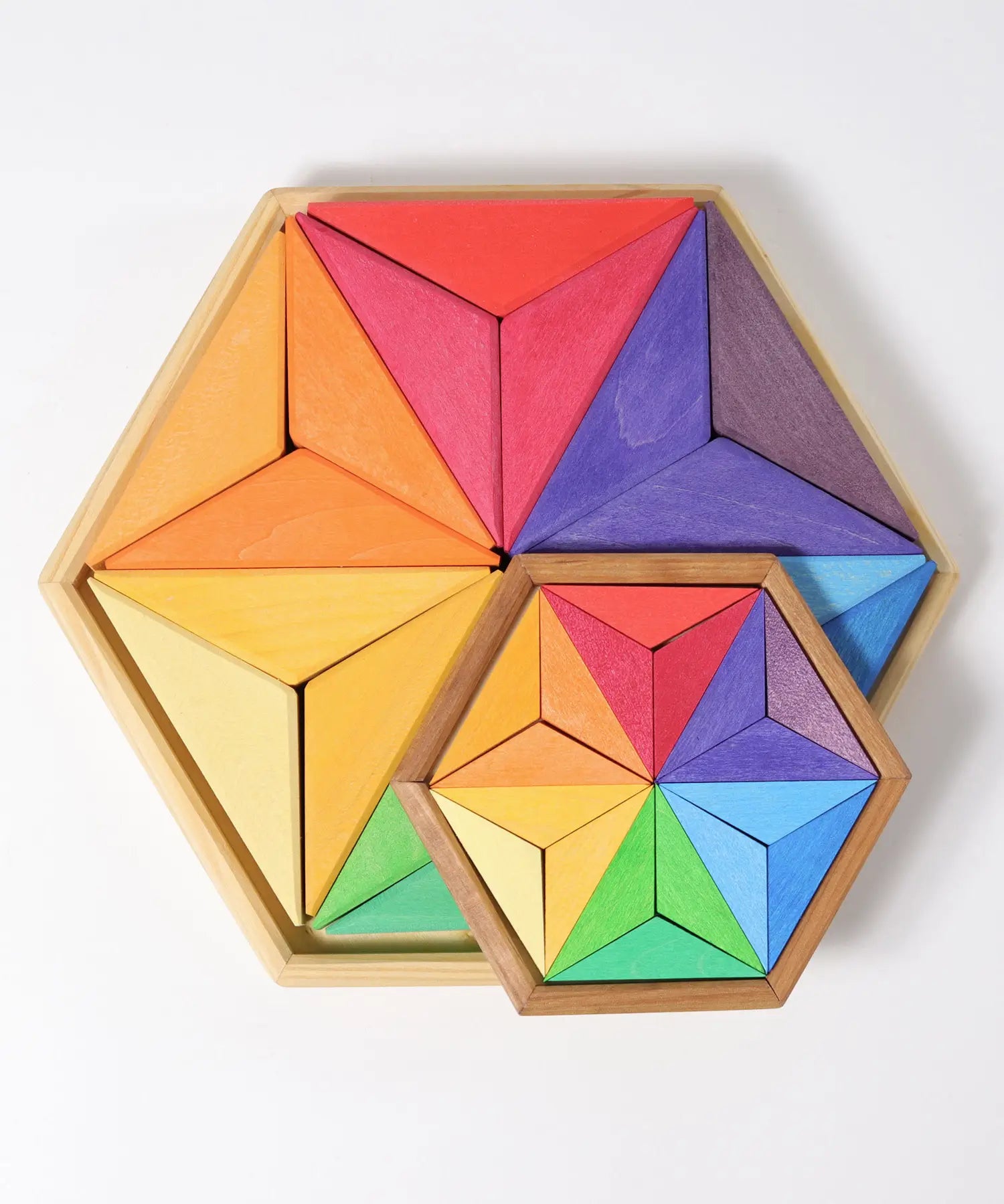Grimms large and small star complementary wooden puzzle sets in a rainbow palette