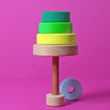 A tree made from loose handcrafted wooden neon green Grimms conical tower pieces
