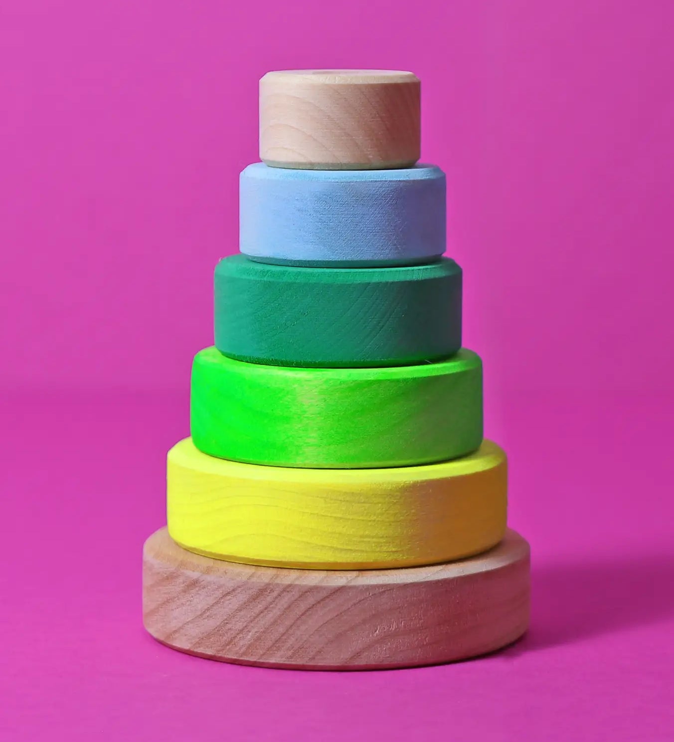 Grimms small handcrafted wooden conical stacking tower in a neon green and natural base, perfect for open ended play