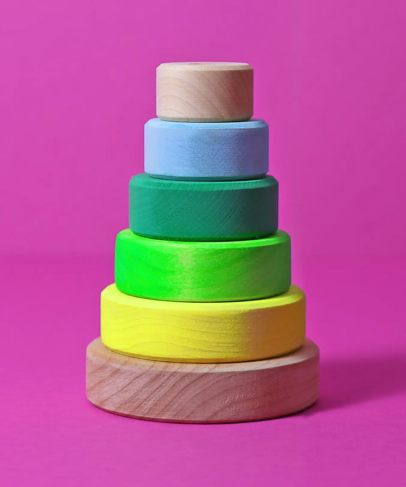 Grimms small handcrafted wooden conical stacking tower in a neon green and natural base, perfect for open ended play