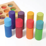 Simple visual fractions using the Grimms small wooden stacking rollers in a rainbow palette