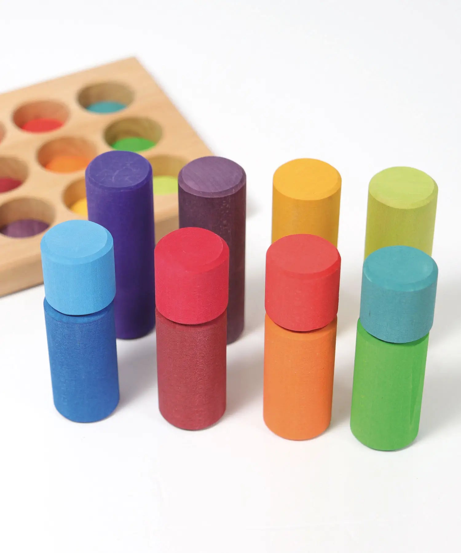 Simple visual fractions using the Grimms small wooden stacking rollers in a rainbow palette