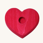 Grimm's Small Red Heart for celebration ring figures and Grimm's candles on a plain background. 