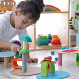 Child playing with the Grimm's small world play in the woods set with other popular building blocks