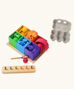 Grimm's small sorting helper wooden boxes 6 piece set with rainbow coloured toys inside.