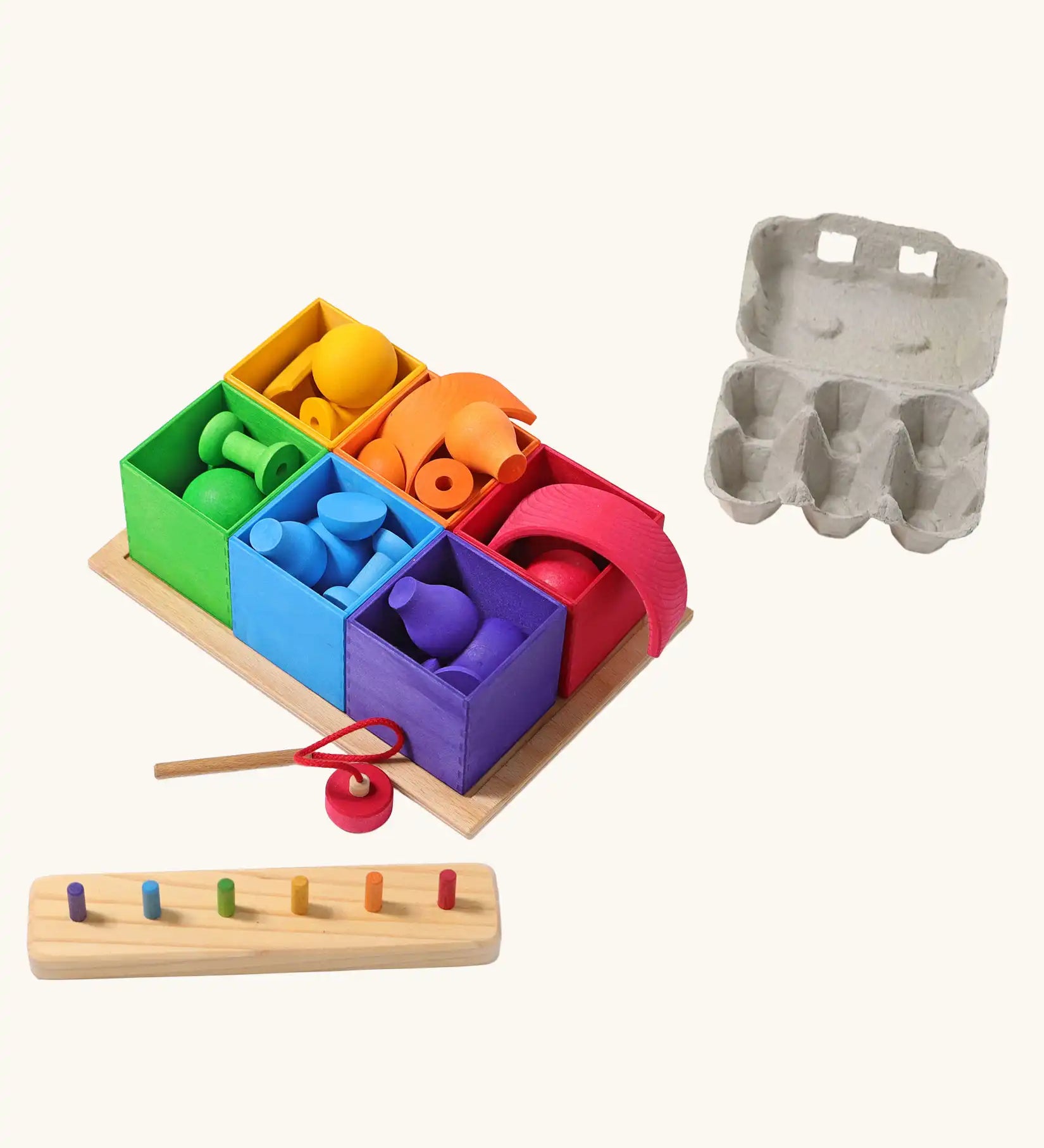 Grimm's small sorting helper wooden boxes 6 piece set with rainbow coloured toys inside.