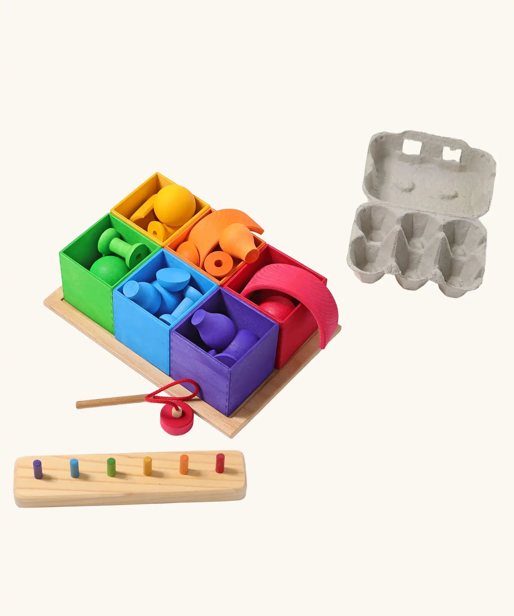 Grimm's small sorting helper wooden boxes 6 piece set with rainbow coloured toys inside.