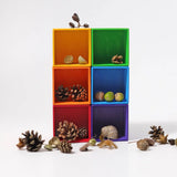 Grimm's small sorting helper wooden boxes 6 piece set with natural pieces such as pine cones. acorns and shells placed inside.