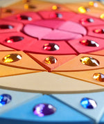 Grimms sparkling sun mandala set showing hand cut detail in the wood and jewel 