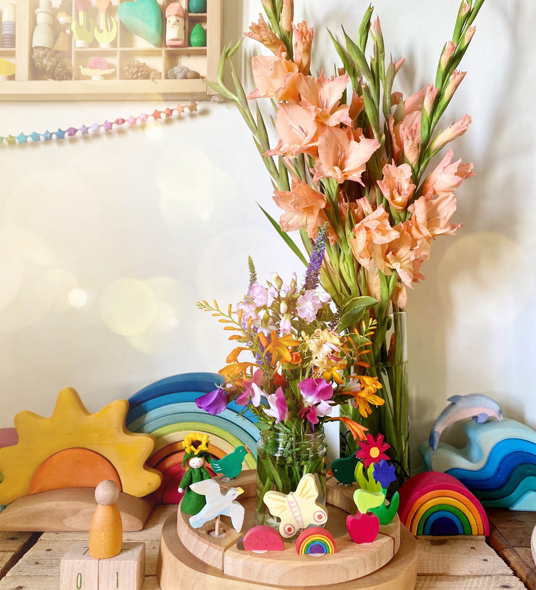 A lovely Spring inspired calendar display using a Grimm's Waldorf Celebration Ring, various Grimm's decorative figures other Grimms building sets available at Babipur.