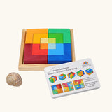 Grimm's square creative set in a wooden storage display tray next o an ideas booklet.