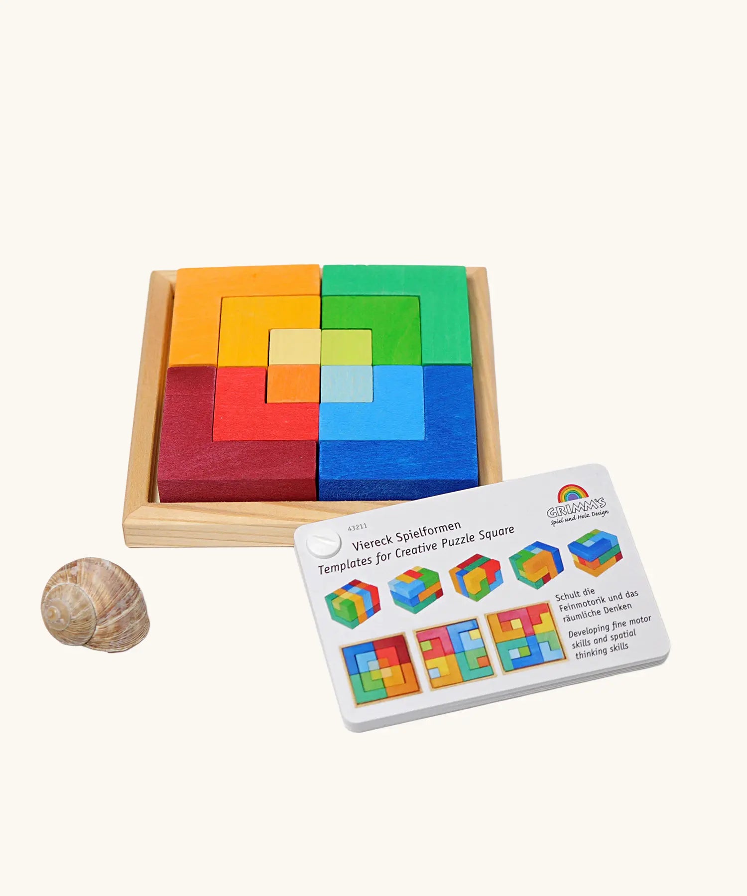 Grimm's square creative set in a wooden storage display tray next o an ideas booklet.