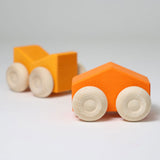 A set of two Grimm's orange wooden toy cars that can be stacked on top of each other. These Grimm's toys are part of a wide range of wooden toys available here at Babipur. 