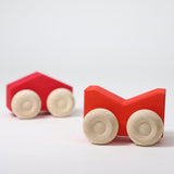 A set of two Grimm's red wooden toy cars that can be stacked on top of each other. These Grimm's toys are part of a wide range of wooden toys available here at Babipur. 