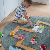 A child playing with the Grimm's Stacking Cars and building boards. Wooden toy cars that comes in a two back that can can be stacked on top of each other.
These Grimm's toys are part of a wide range of wooden toys available here at Babipur. 