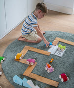 A child playing with the Grimm's Stacking Cars and building boards. Wooden toy cars that comes in a two back that can can be stacked on top of each other.
These Grimm's toys are part of a wide range of wooden toys available here at Babipur. 