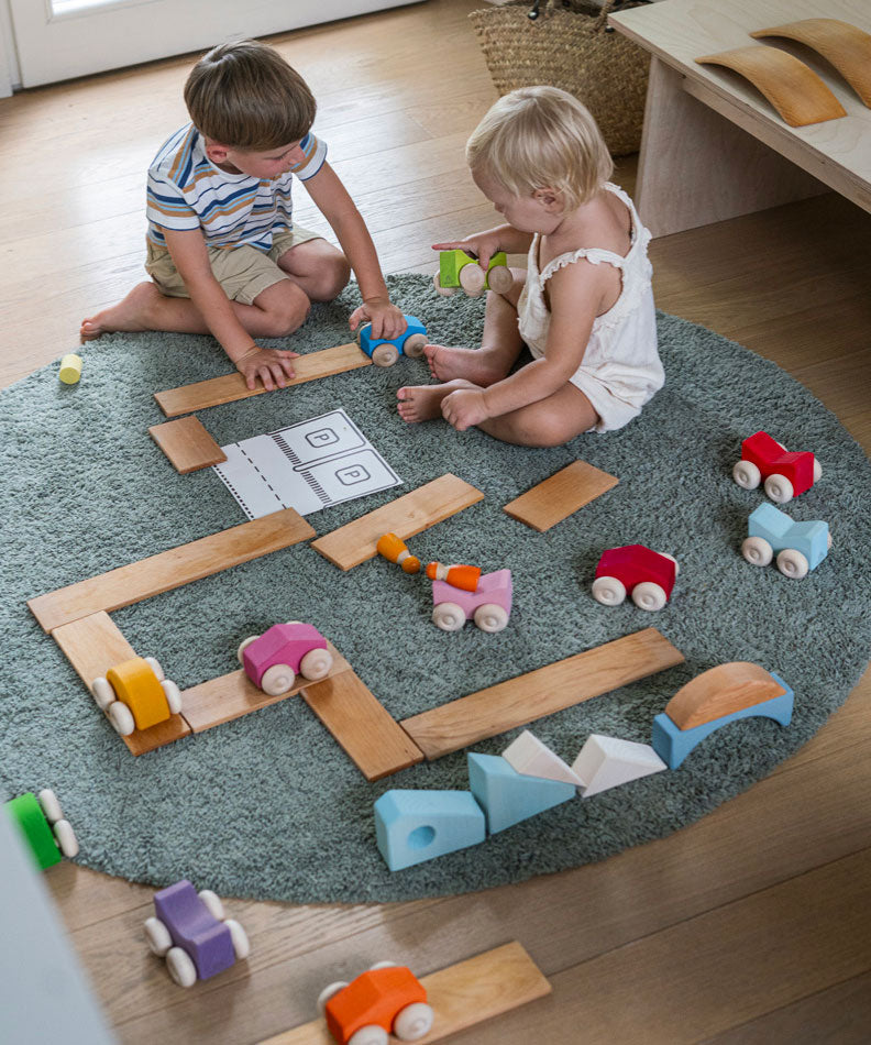 Chldren playing with the Grimm's Stacking Cars and Grimm's natural building boards. Wooden toy cars that comes in a two back that can can be stacked on top of each other.
These Grimm's toys are part of a wide range of wooden toys available here at Babipur.