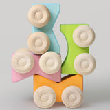 Four Grimm's stacking cars in pastel coloured shades stacked on top of each other. These Grimm's toys are part of a wide range of wooden toys available here at Babipur. 