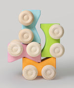 Four Grimm's stacking cars in pastel coloured shades stacked on top of each other. These Grimm's toys are part of a wide range of wooden toys available here at Babipur. 