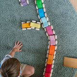 A child playing with the Grimm's Stacking Cars lining them all up on a rug. Wooden toy cars that comes in a two back that can can be stacked on top of each other.
These Grimm's toys are part of a wide range of wooden toys available here at Babipur. 
