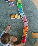 A child playing with the Grimm's Stacking Cars lining them all up on a rug. Wooden toy cars that comes in a two back that can can be stacked on top of each other.
These Grimm's toys are part of a wide range of wooden toys available here at Babipur. 