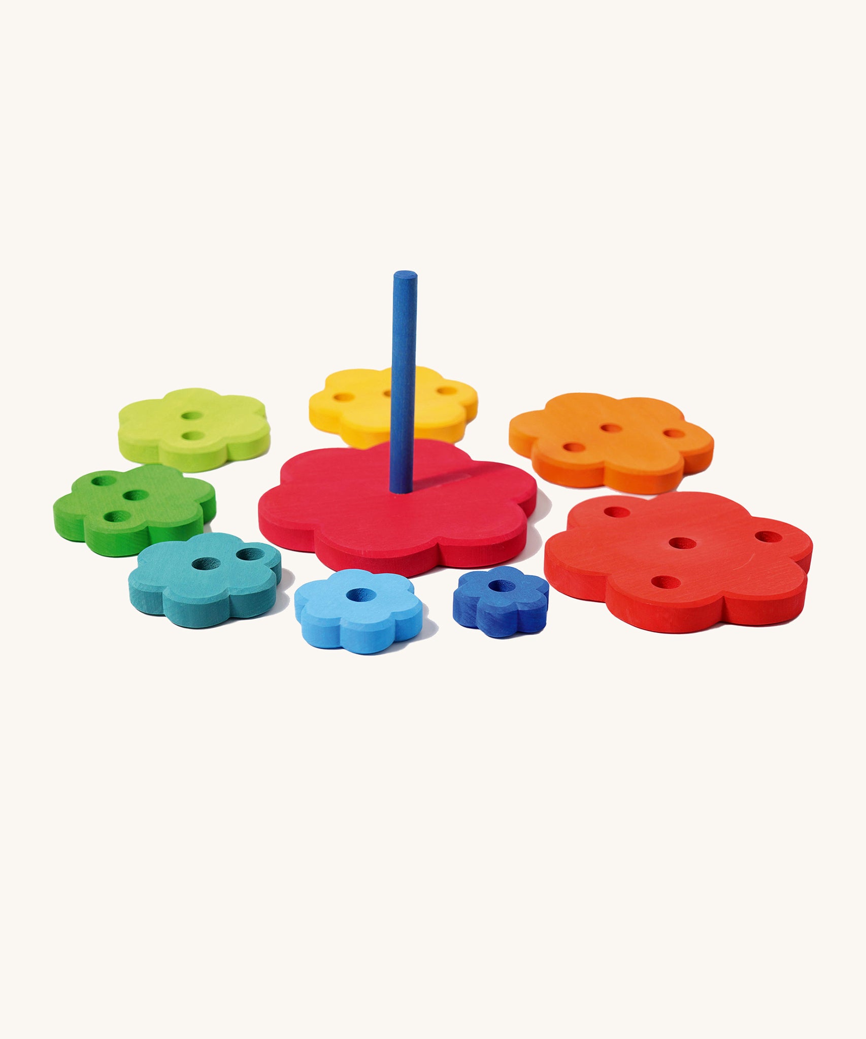 Grimm's Stacking rainbow Flowers Tower on a plain background. The pieces have taken off the base piece and laid out around it. 