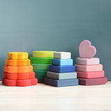 The flower, leaf, square and heart pieces of the Grimms stacking tower set stacked 