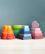 The flower, leaf, square and heart pieces of the Grimms stacking tower set stacked 
