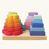 Grimms handcrafted Waldorf stacking tower in various shapes includes 20 wooden pieces hat slot into the pegs.