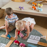 Children playing with the Grimm's Stacking Cars and natural building boards. Wooden toy cars that comes in a two back that can can be stacked on top of each other.
These Grimm's toys are part of a wide range of wooden toys available here at Babipur. 