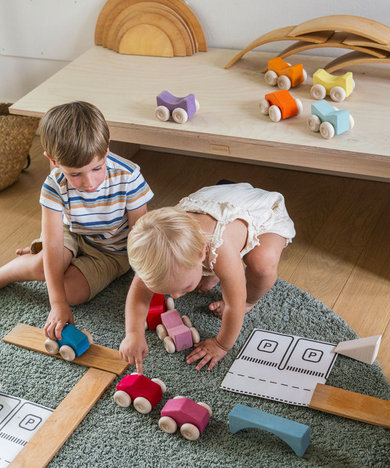 Children playing with the Grimm's Stacking Cars and natural building boards. Wooden toy cars that comes in a two back that can can be stacked on top of each other.
These Grimm's toys are part of a wide range of wooden toys available here at Babipur. 