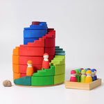 The Grimm's Counter-Rotating Stepped Spiral wooden block set pictured with the Grimm's rainbow friends.